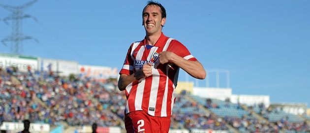 GETAFE, SPAIN - APRIL 13:  Diego Godin of Club Atletico de Madrid celebrates after scoring his team's opening goal during the La  Liga match between Getafe CF and Club Atletico de Madrid at Coliseum Alfonso Perez stadium on April 13, 2014 in Getafe, Spain.  (Photo by Denis Doyle/Getty Images)