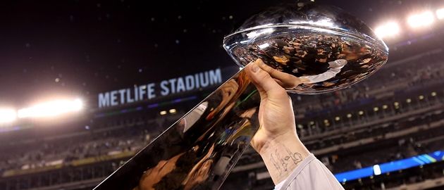 EAST RUTHERFORD, NJ - FEBRUARY 02:  A Seattle Seahawk holds up the Vince Lombardi Trophy after their 43-8 win over the Denver Broncos during Super Bowl XLVIII at MetLife Stadium on February 2, 2014 in East Rutherford, New Jersey.  (Photo by Jeff Gross/Getty Images)