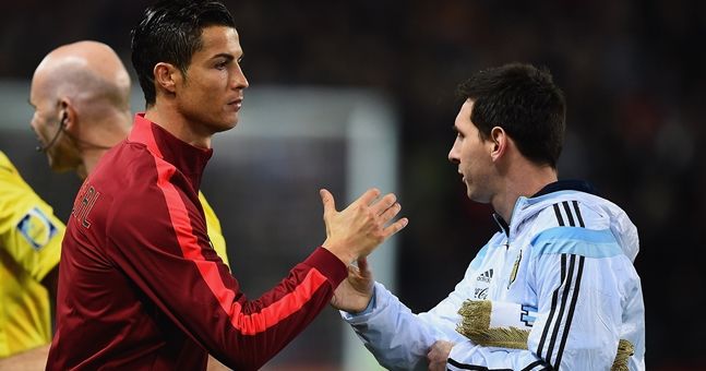 MANCHESTER, ENGLAND - NOVEMBER 18:  Cristiano Ronaldo of Portugal shakes hands with Lionel Messi of Argentina prior to the International Friendly between Argentina and Portugal at Old Trafford on November 18, 2014 in Manchester, England.  (Photo by Laurence Griffiths/Getty Images)