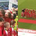 Cliftonville players keep their heads bowed during God Save the Queen before Irish Cup final against Coleraine