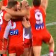 Colin O’Riordan’s Swans teammates swarm him as he kicks first goal for Sydney