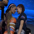 MMA fighters surprise crowd by kissing at face-off and flashing their breasts
